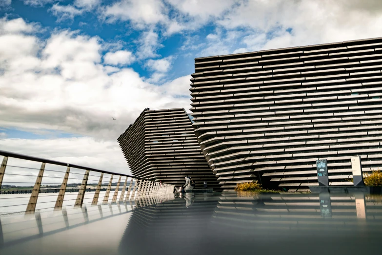 two black and white building facing a body of water