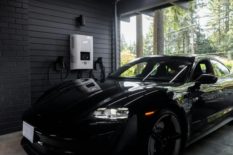 a black car is charging in a garage