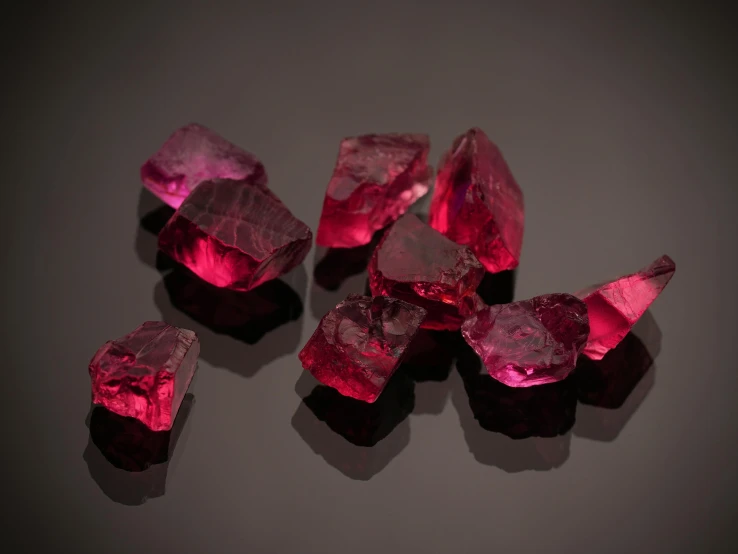 purple crystals are on a table, against a gray background