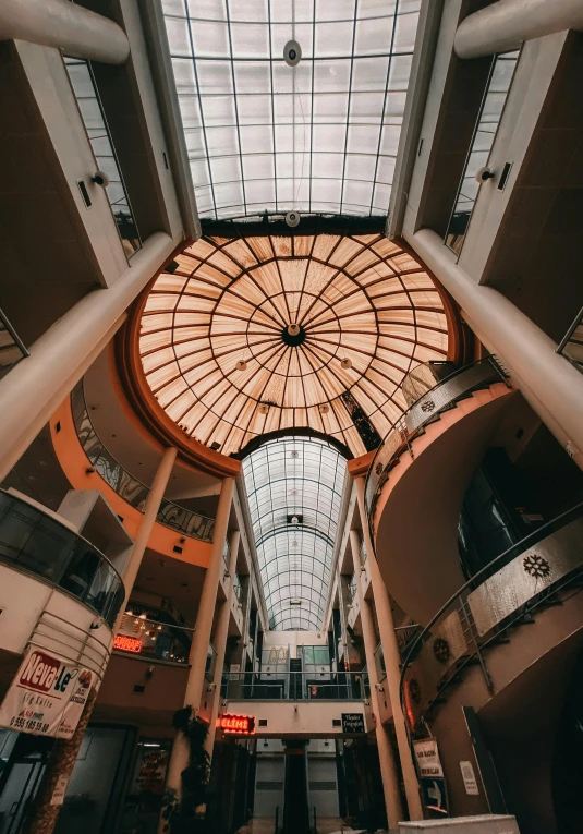 an empty store is seen from below as the light fixture hangs above