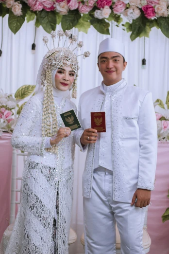 a woman and man dressed in white smile for a picture