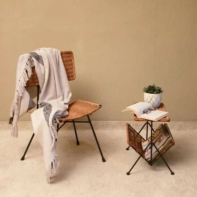 two empty wooden chairs with a blanket and a book