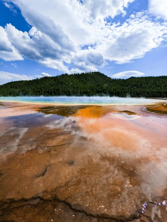 a lake that has a small body of water with colorful rocks