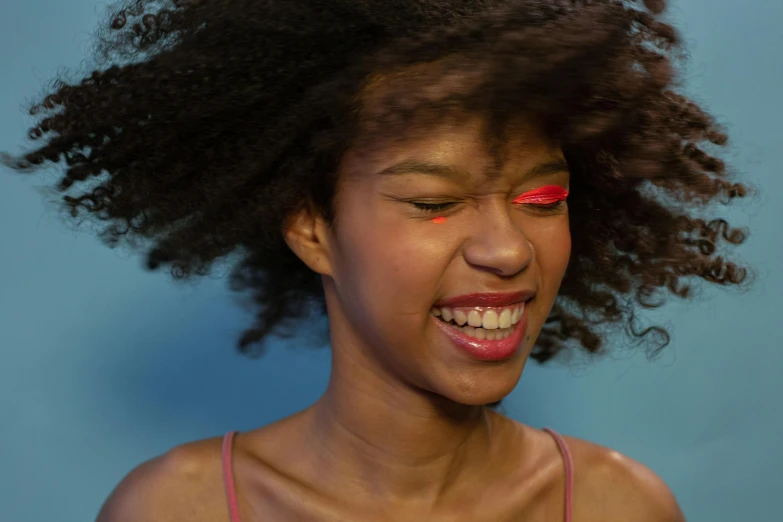 an african woman with a pair of red eye shadow makeup