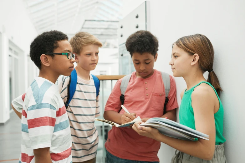 four boys and girls talking in line, all lined up