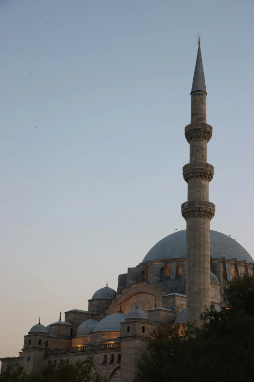 an intricately designed building in front of a sunset sky