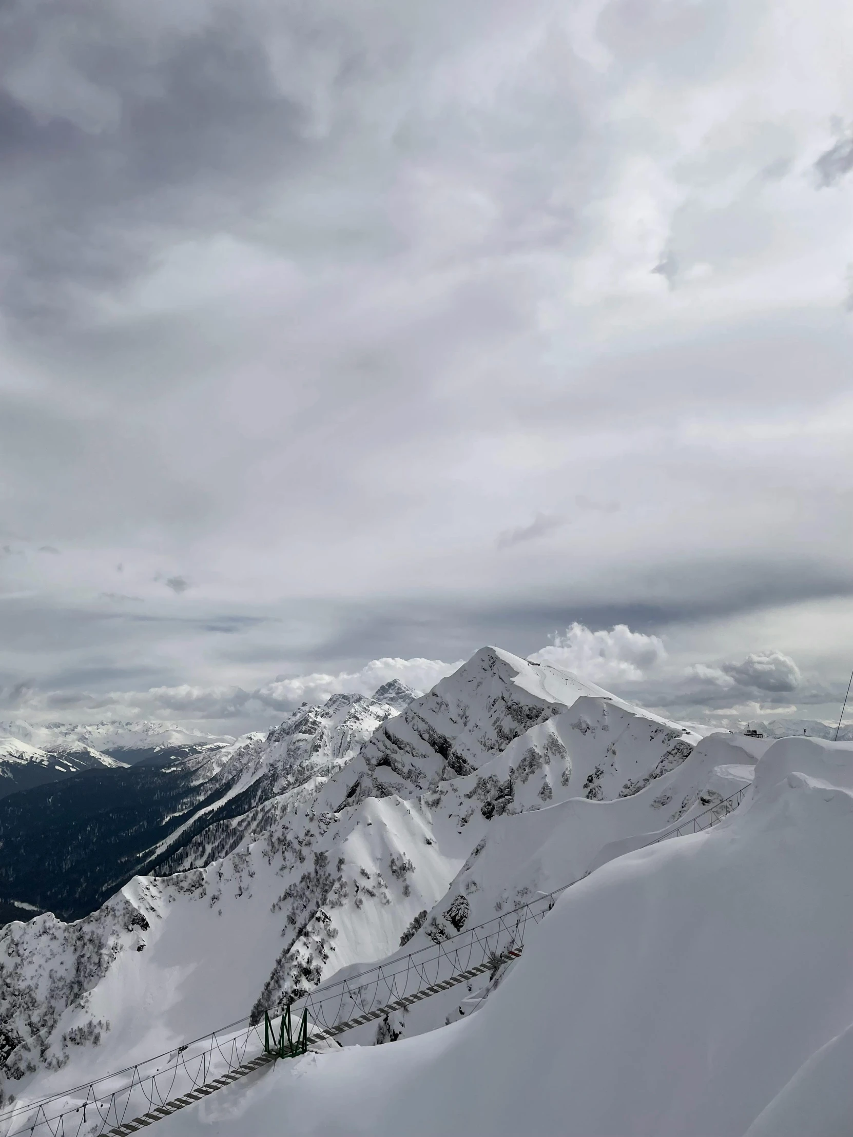 skiers are on the top of a snowy mountain