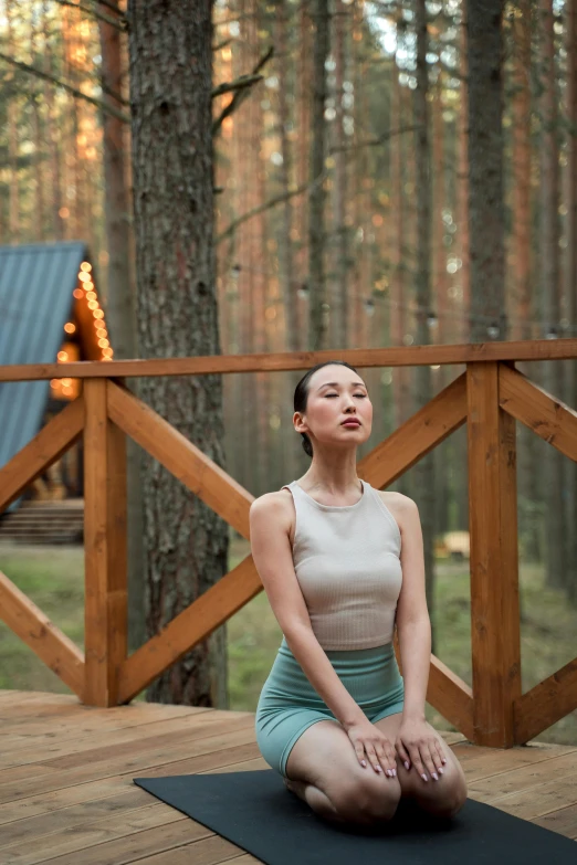 a woman is sitting on a yoga mat