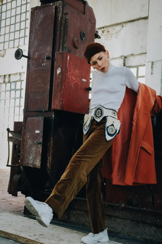 a woman is leaning on an old, red piece of furniture