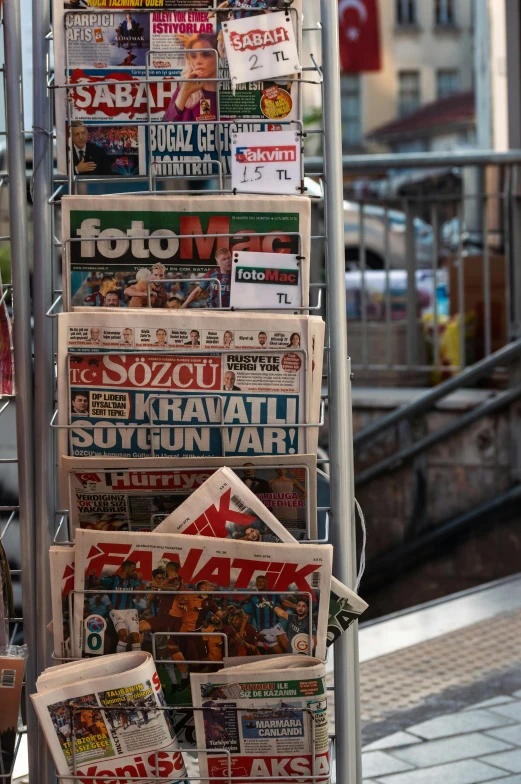 a bunch of newspapers are stacked on top of each other