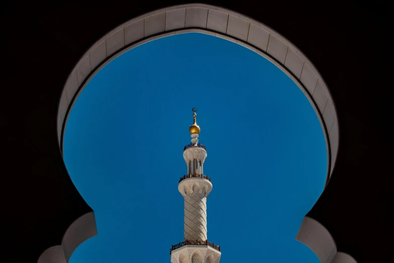 a tall and white building with a pointed tower