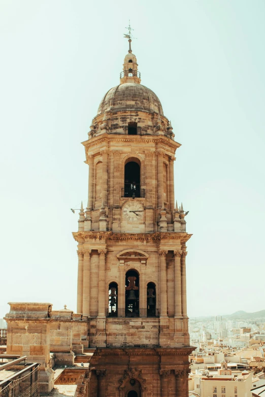 an old church tower with a bell on it's side