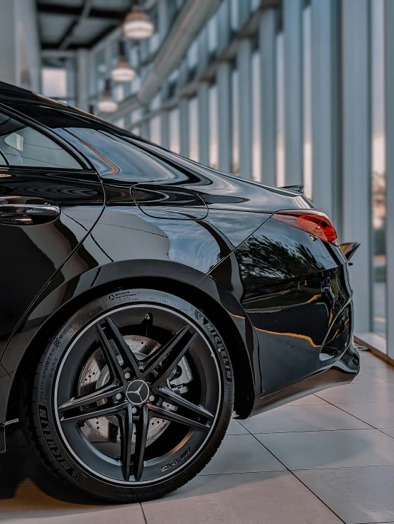 a black sports car sits parked in a parking garage