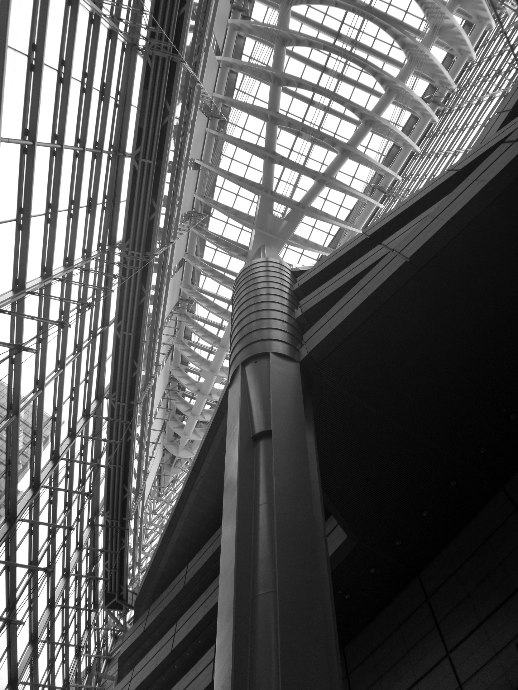 the inside of an airport has glass and metal