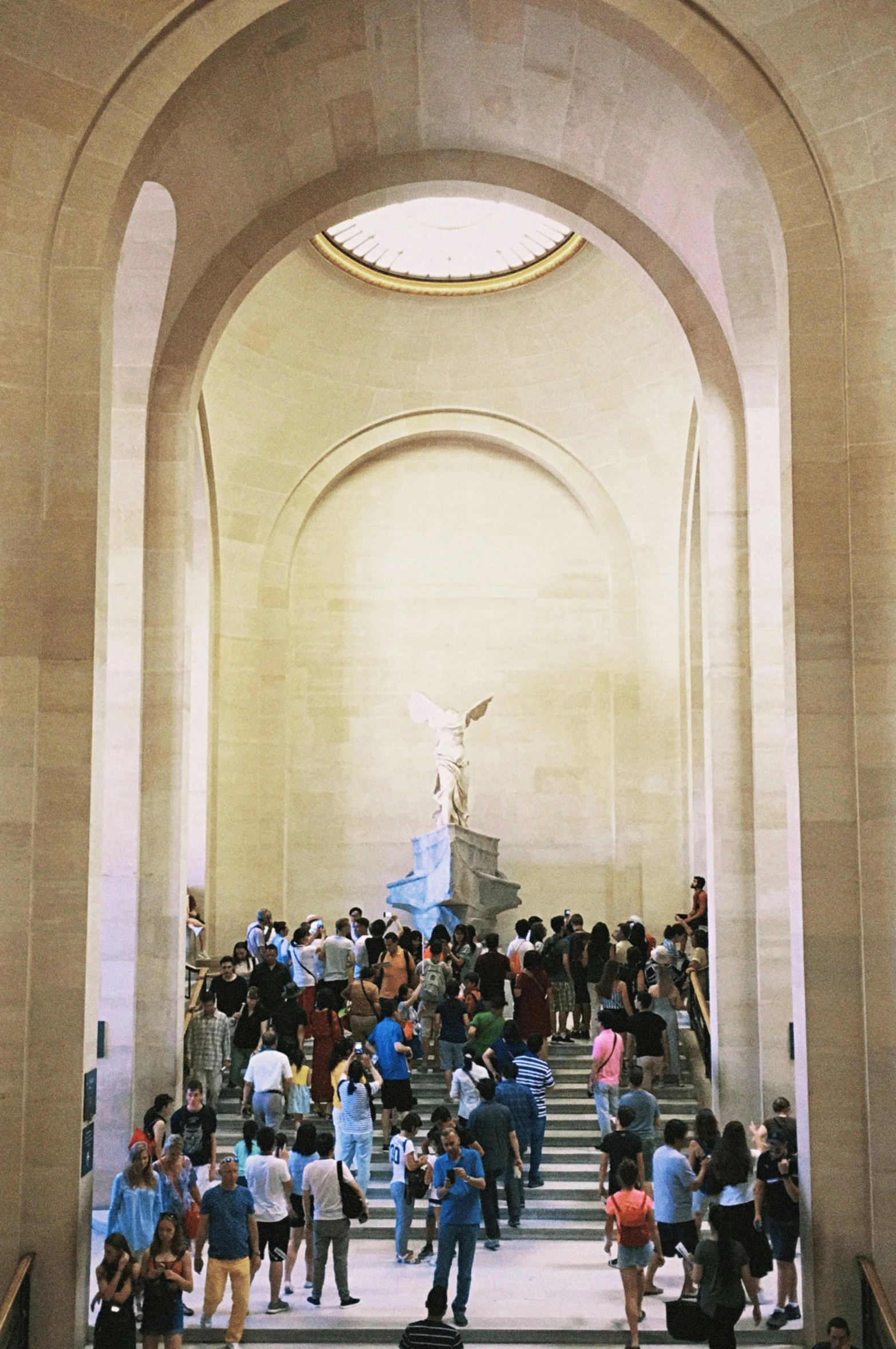 a crowd of people walking up and down a flight of stairs