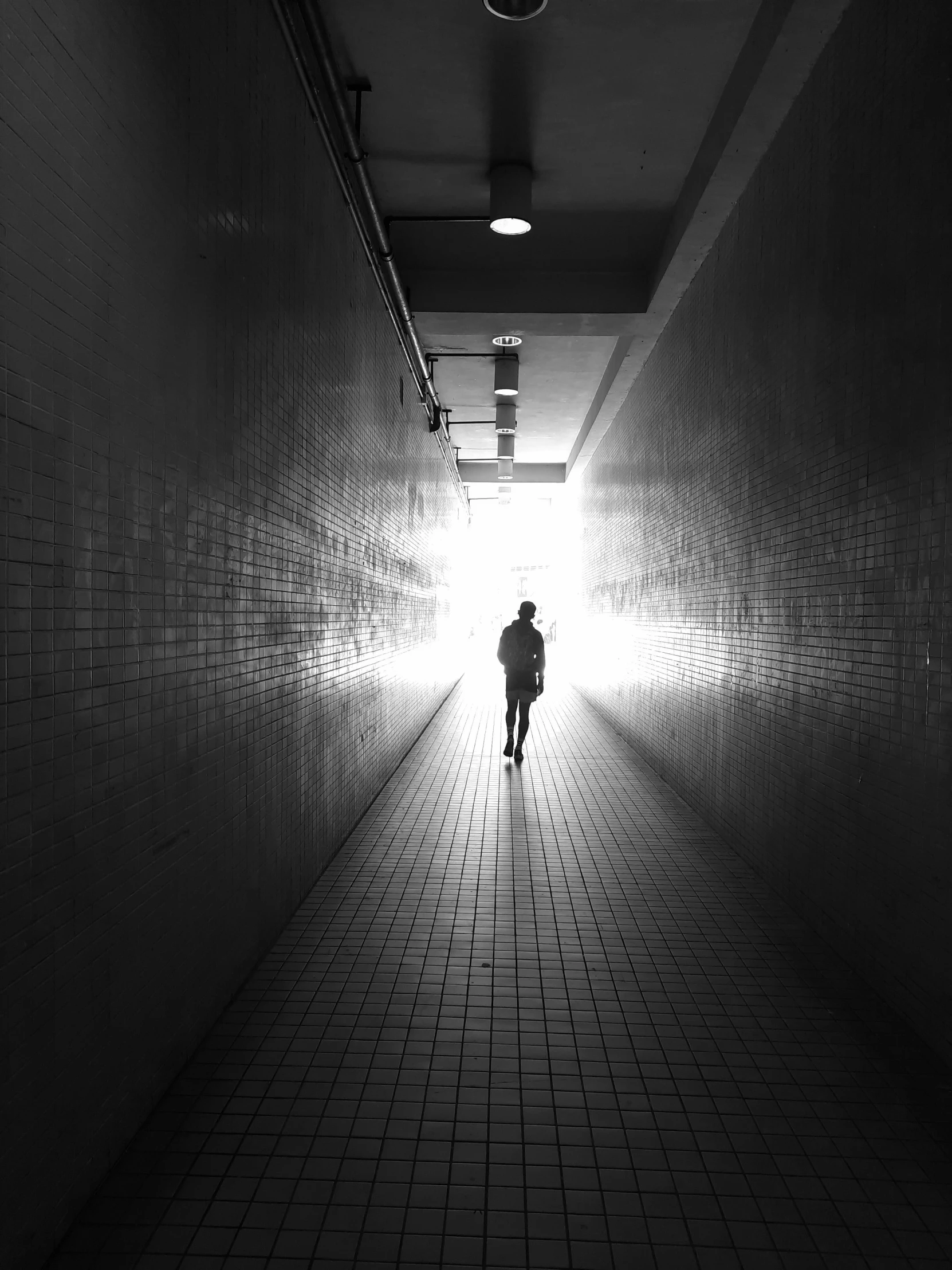 a person is walking down a long hall