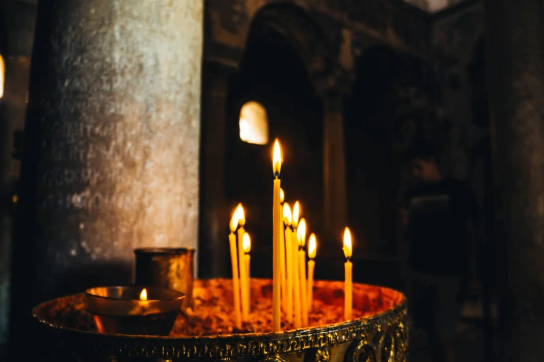 lit candles in the interior of a church