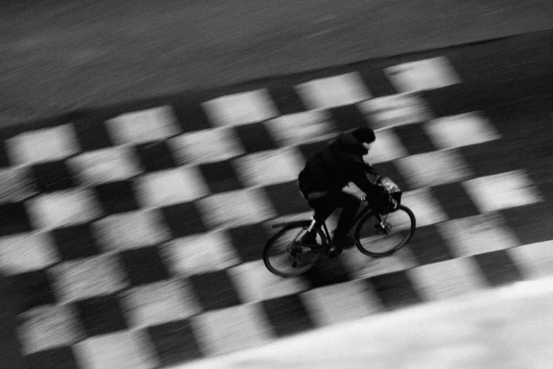 man riding his bicycle on the street near the sidewalk