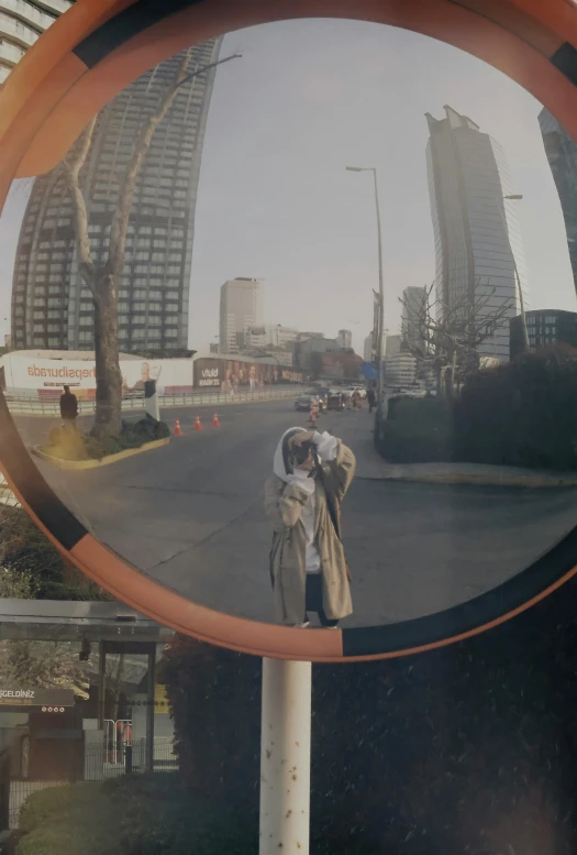 a woman in a white dress and man on a street with cars in the background