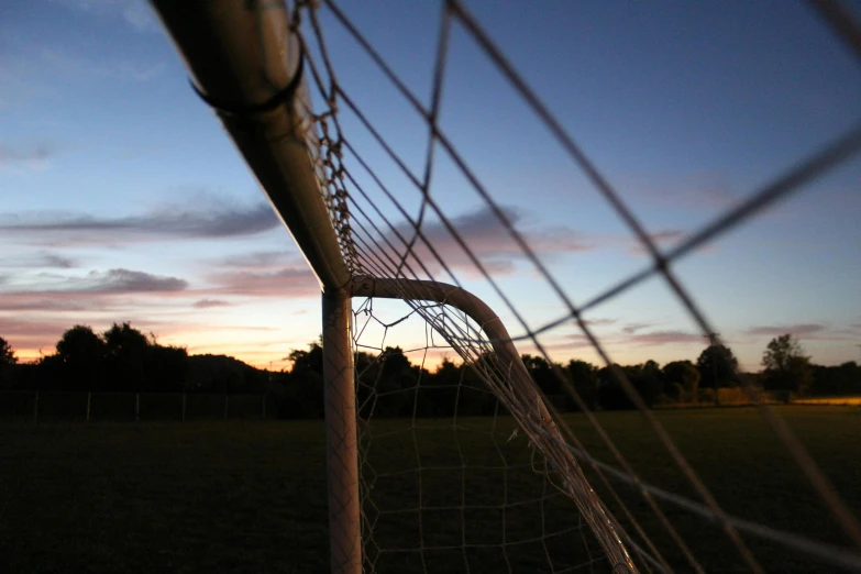 the goalpost in the soccer field is pointed toward the sky