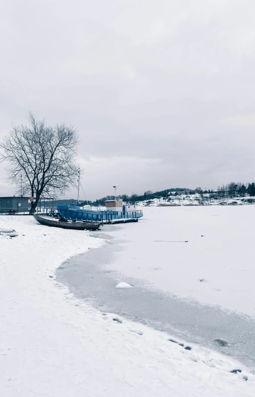 a truck parked in the snow by a small house