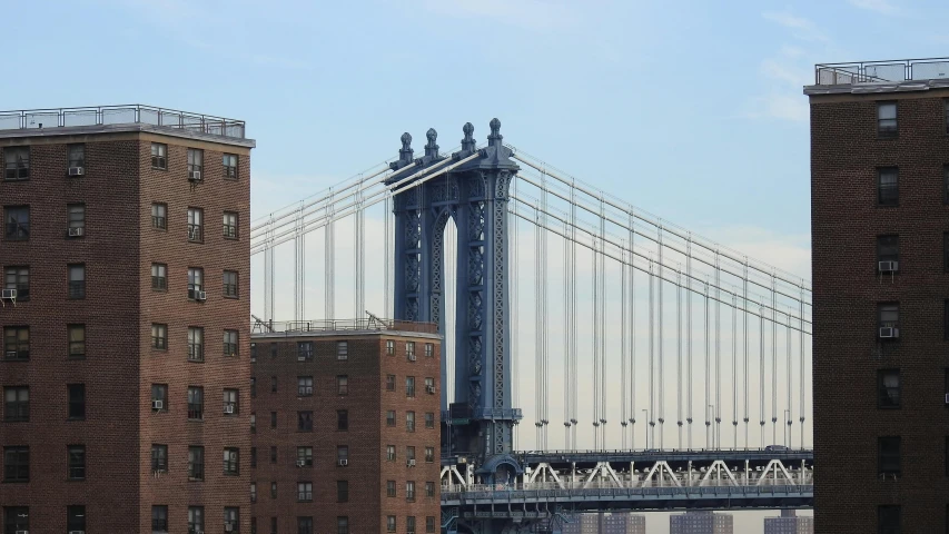 two large brick buildings and a suspension bridge