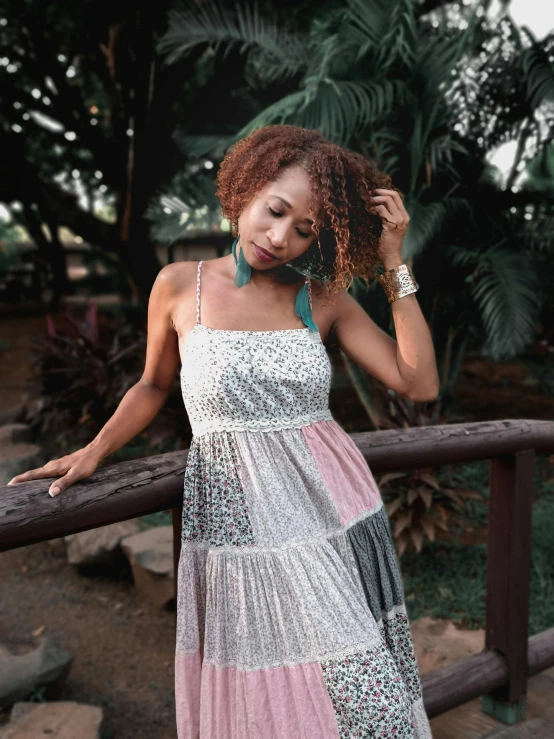 a woman posing in a colorful dress for the camera