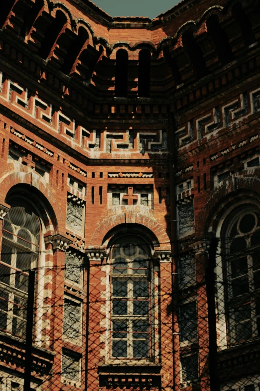 a very tall brick building with three windows