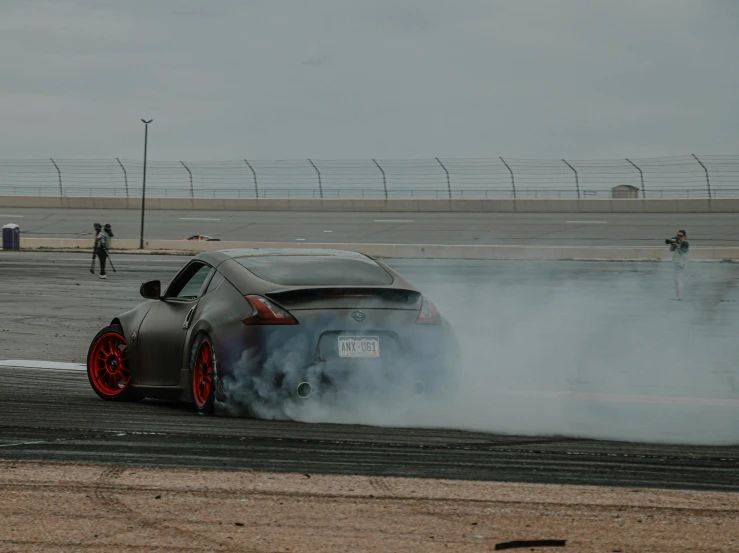 a sports car on the road with a lot of smoke coming out of it