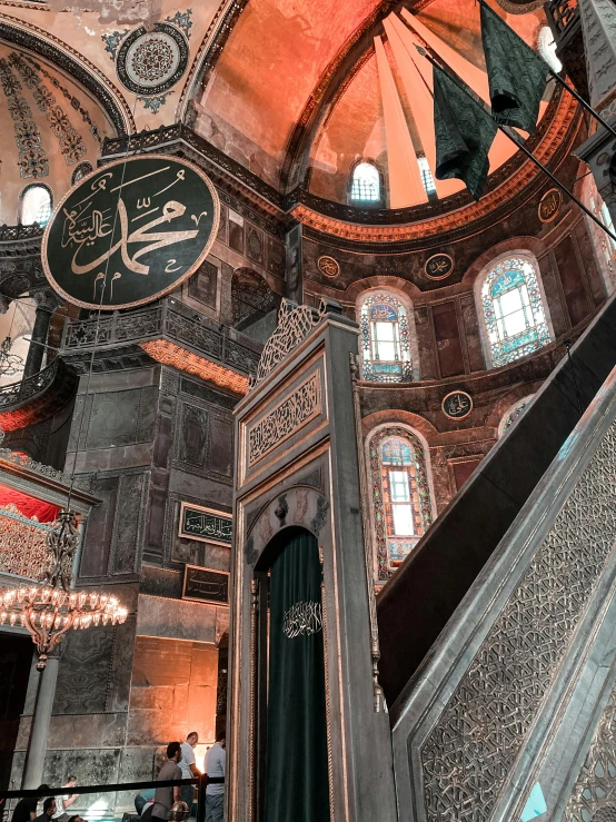 inside a grand ornate building with stained glass windows