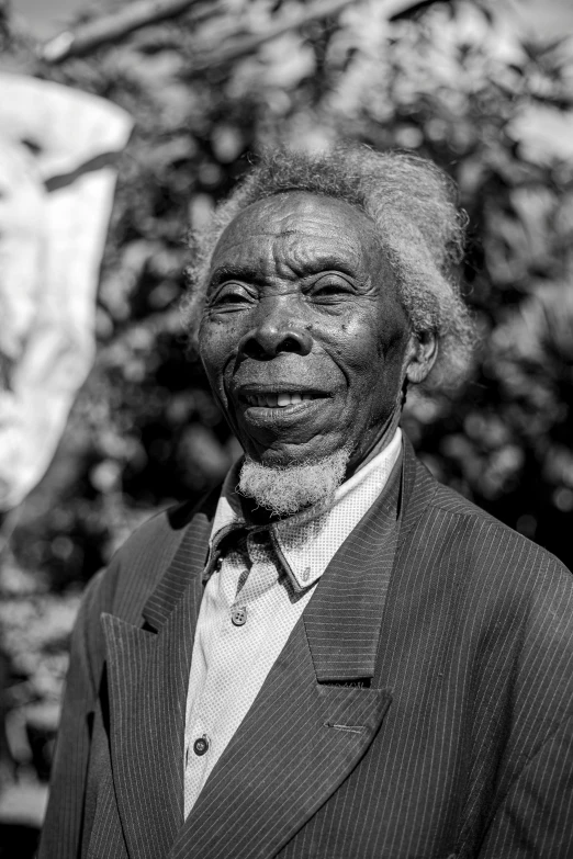 a man with a suit and tie in black and white