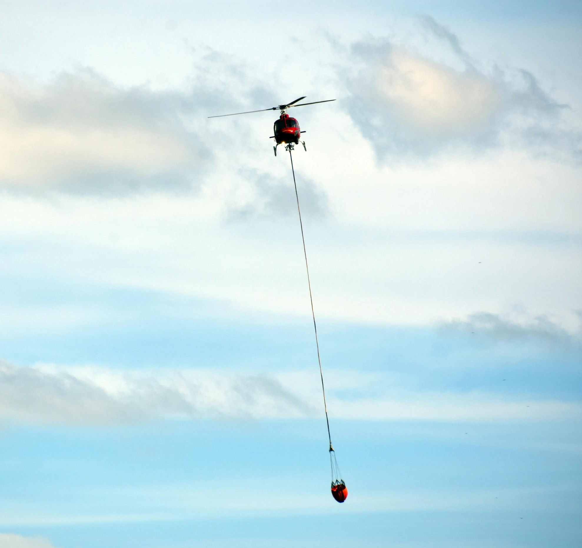 a helicopter being attached to a rope by a string