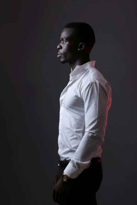 man in white shirt and black pants posing for picture
