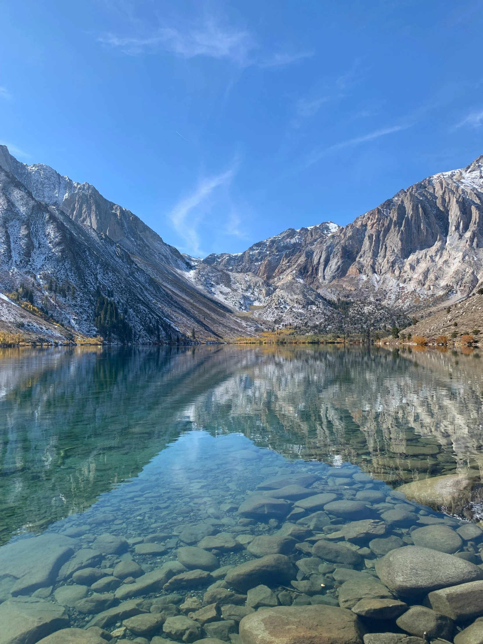 a mountain lake near a cliff and sky