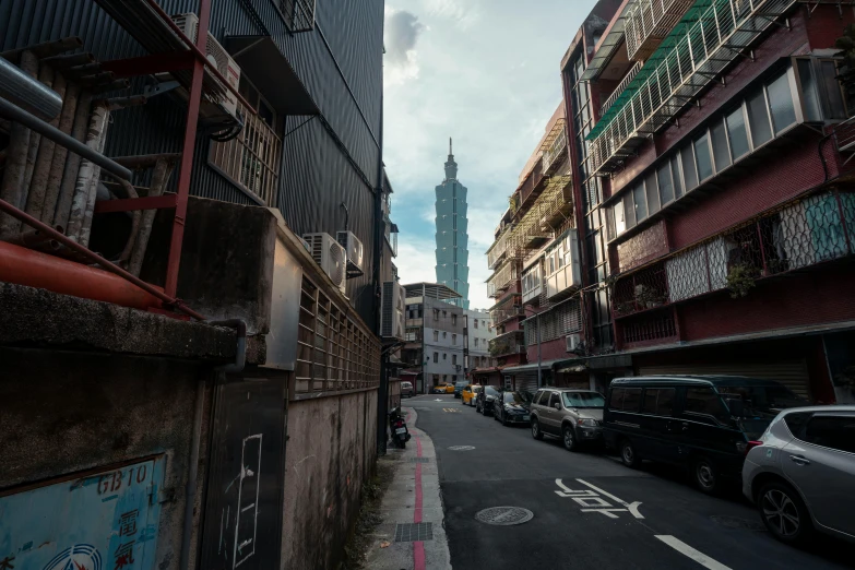 a city street with tall buildings and a lot of graffiti