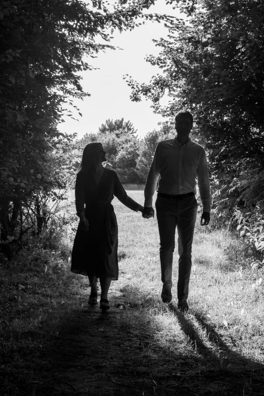 a man and woman holding hands walking together