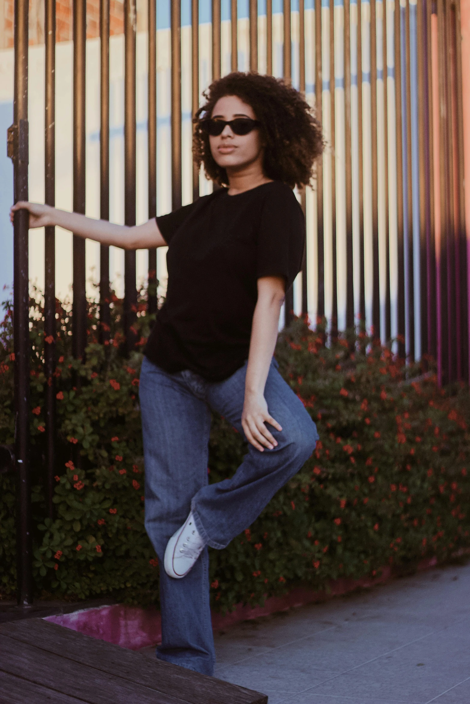 a woman is skateboarding in front of a gate