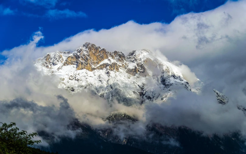 the snow capped peaks in a blue sky