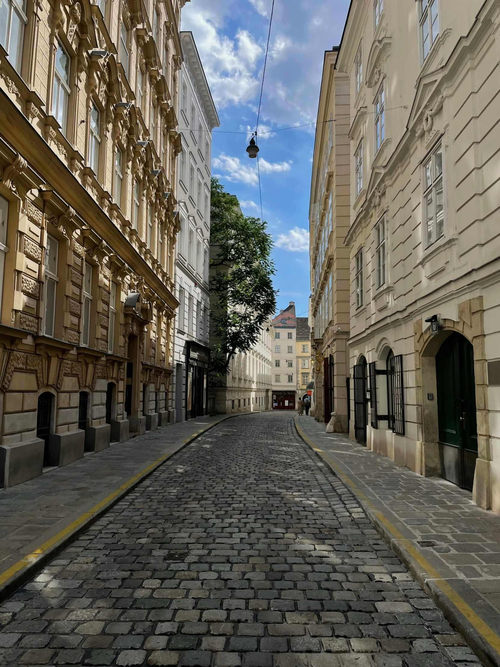 a cobble stone road leading to buildings