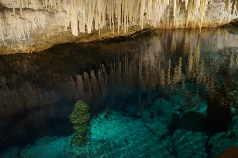 clear water in the crystal lake with many formations hanging from it's sides