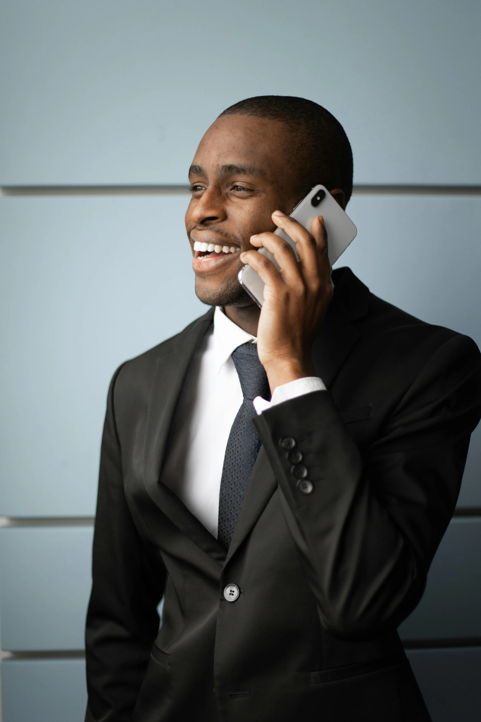 a man wearing a suit and tie talking on the phone