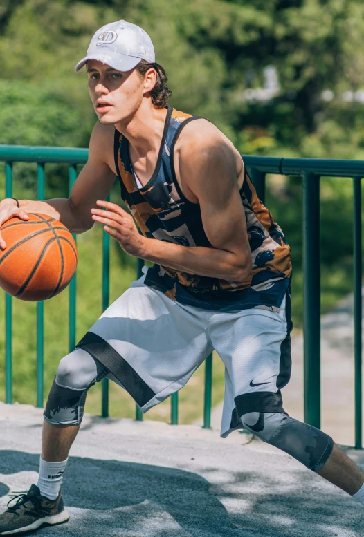 a young man holding a basketball in his hand