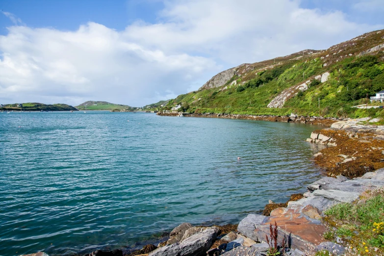 a body of water surrounded by a hill