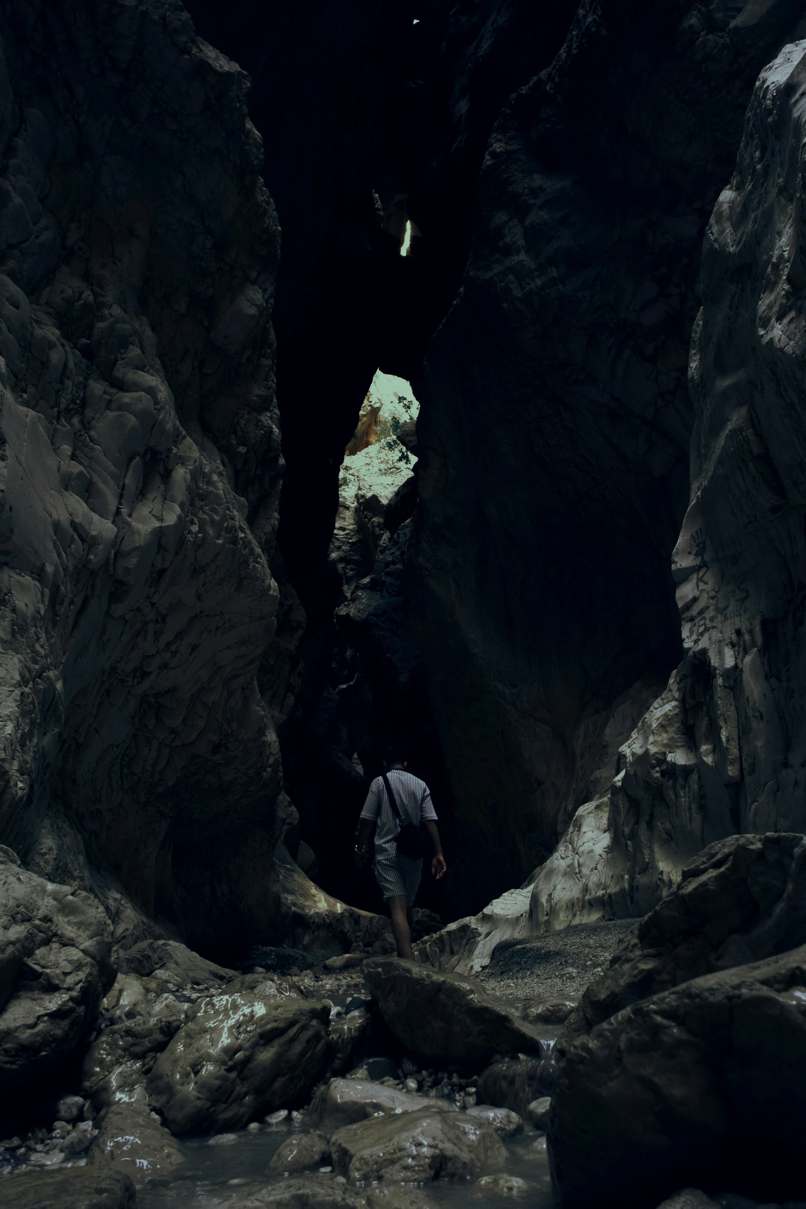 a man standing in a tunnel in the middle of some rocks