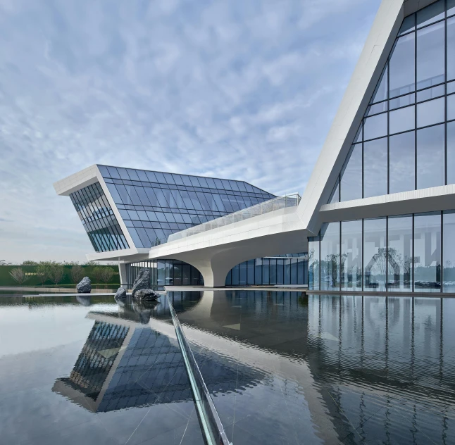 modern architecture in front of an office building with water reflecting off the glass windows