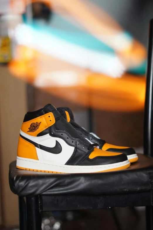 a pair of yellow and black nike air jordans