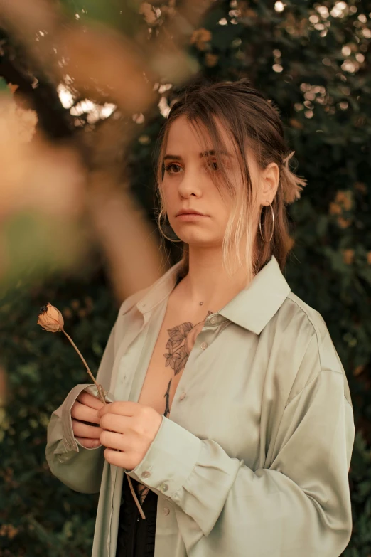 a woman holding a rose in her left hand