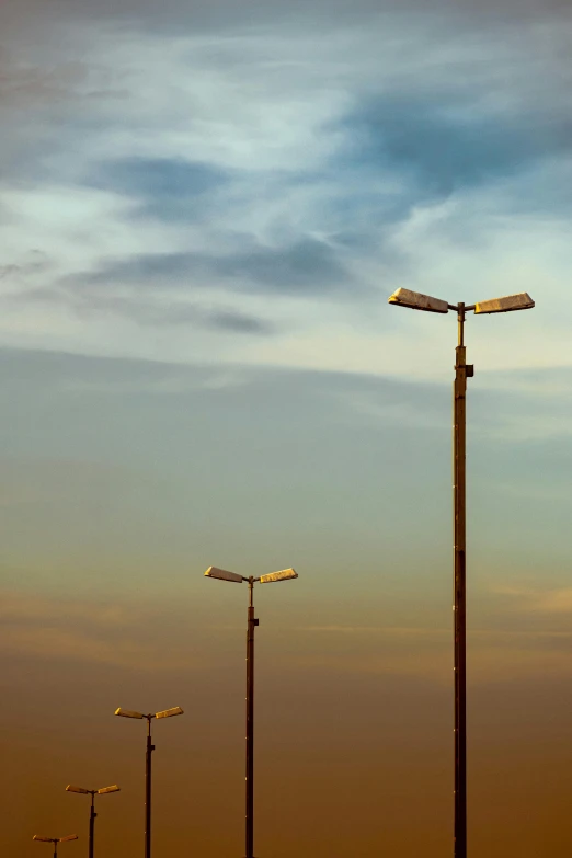 a few street lights in the sky with street signs