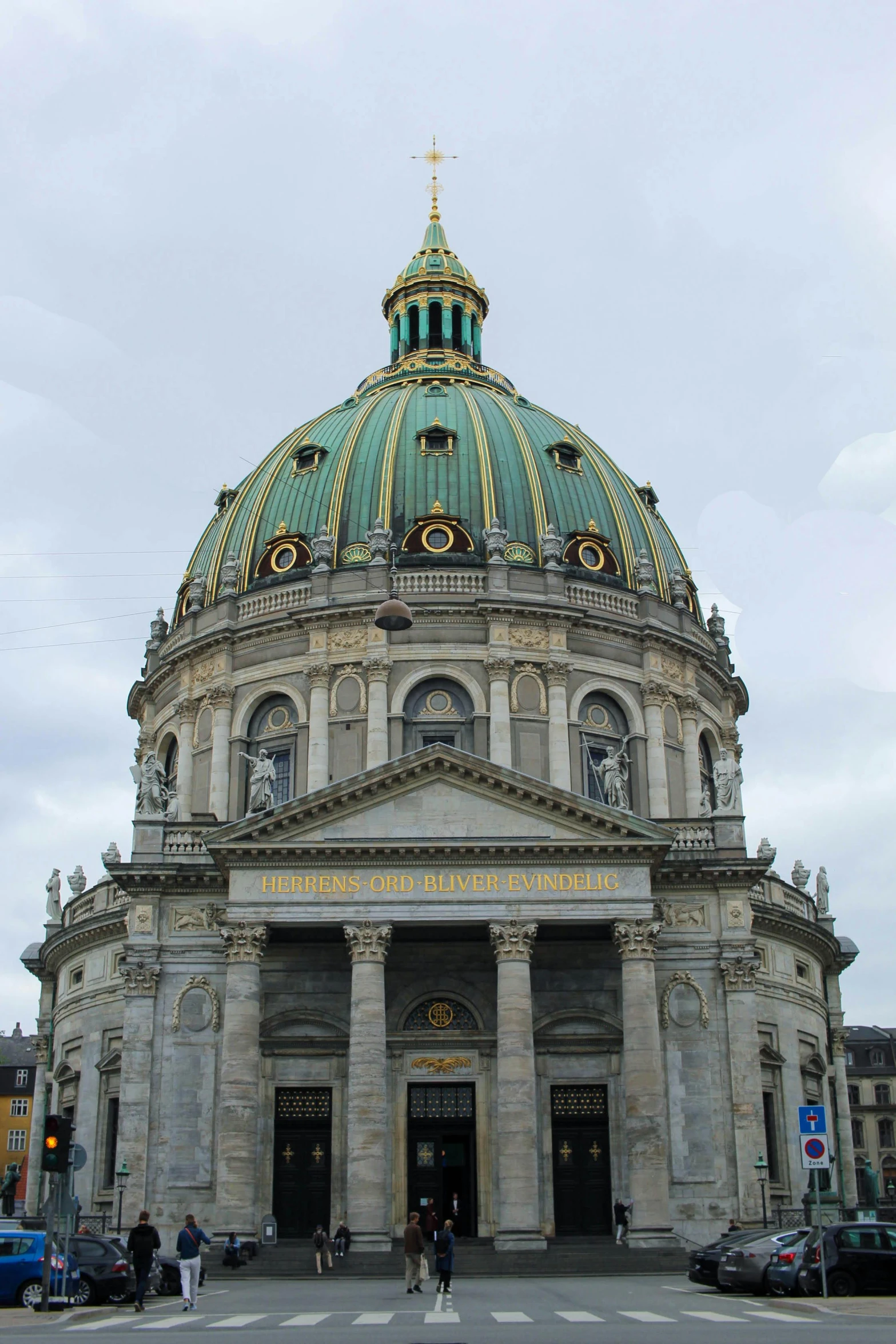 people walking on street in front of a large building