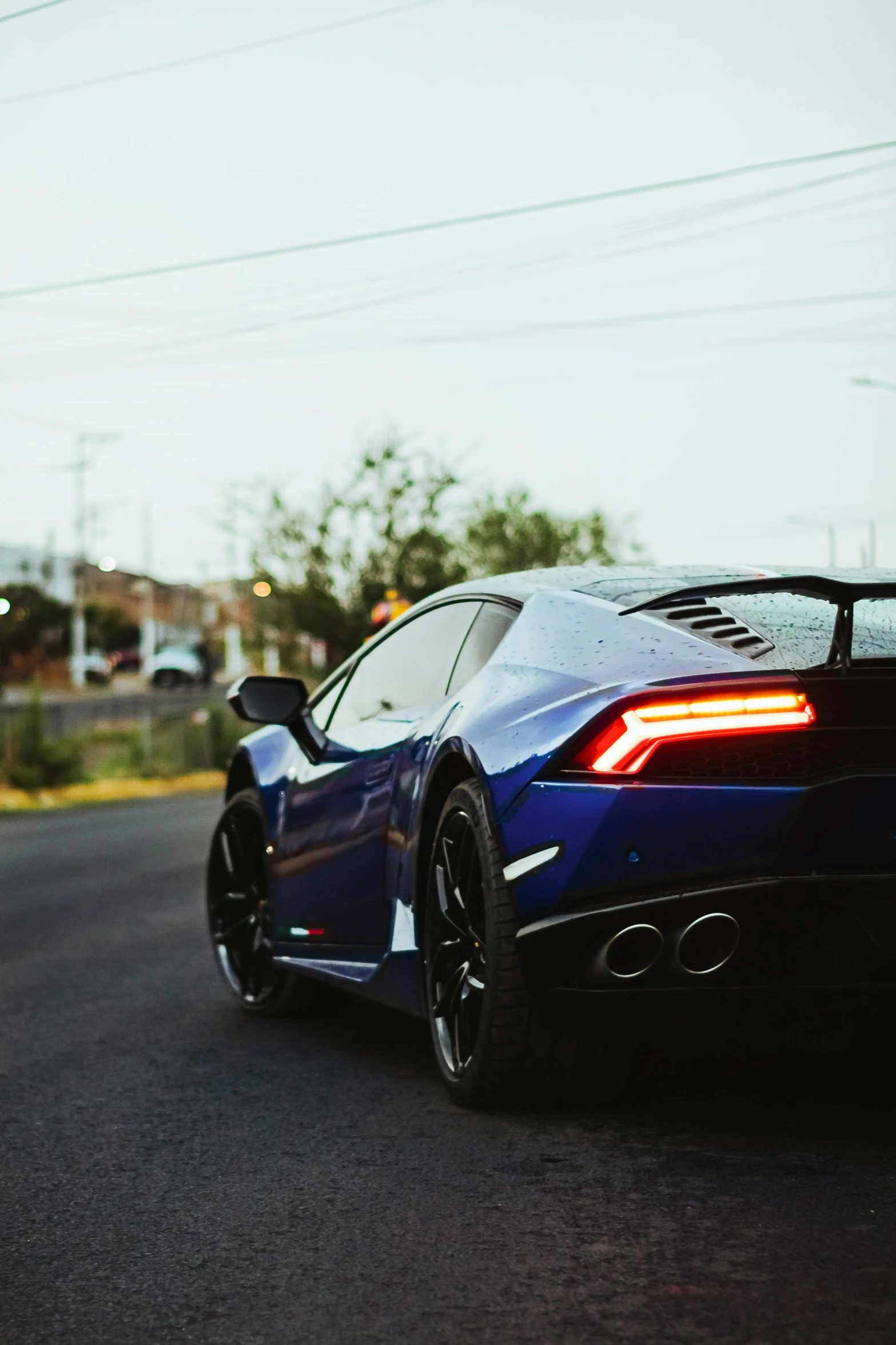 a black and blue sports car is parked by itself